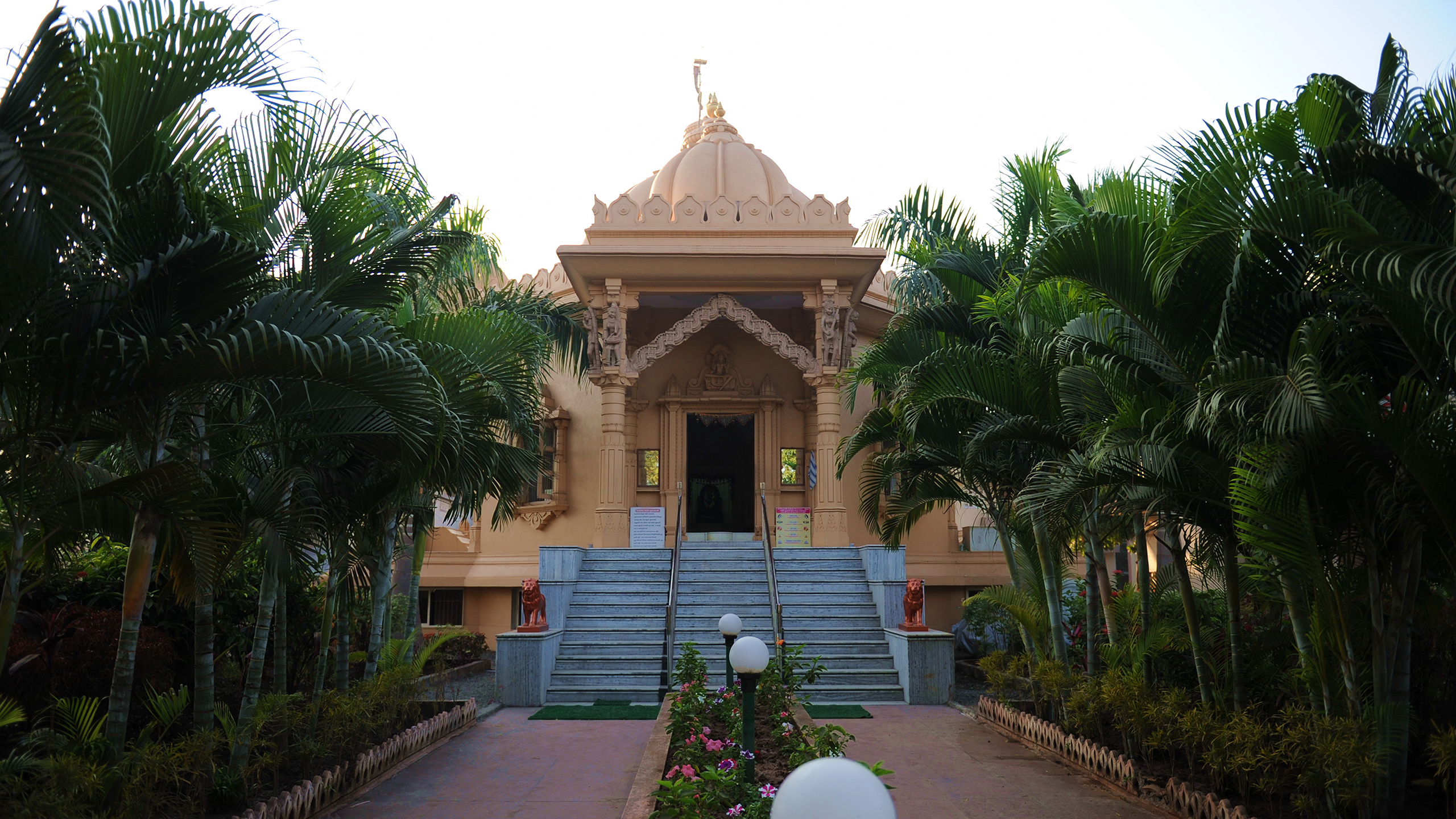 The sandstone derasar at Shantiniketan, framed by palms at dawn